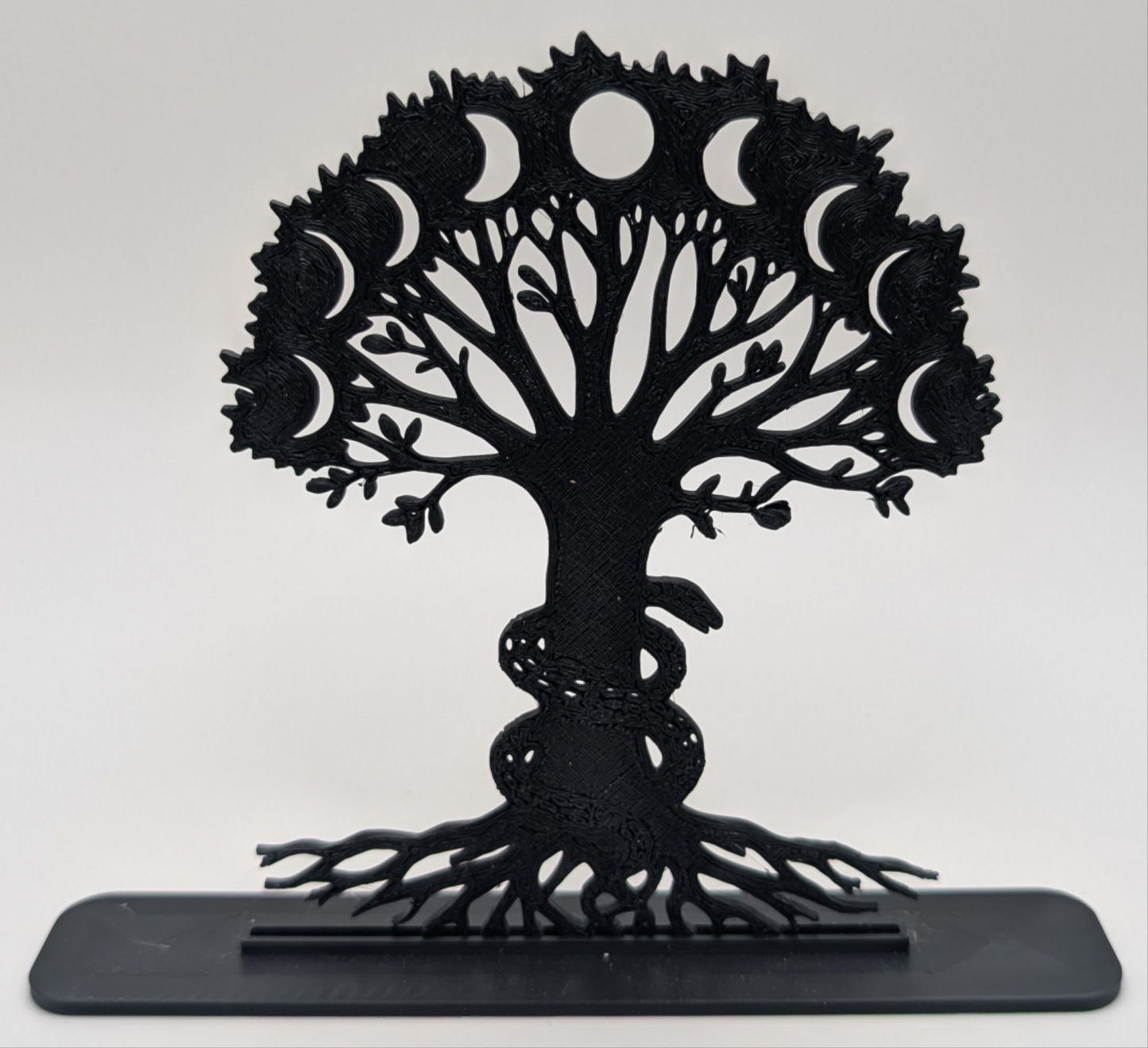 Modern Tree of Life tabletop ornament featuring lunar cycle and serpent detail, minimalist black design for home or altar use