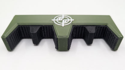 Green and black metal component with a logo on a white background