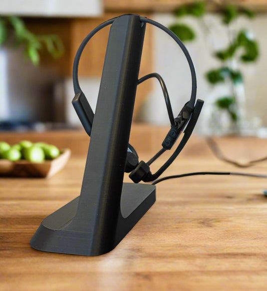 Shokz Charging Stand in Black on Desk,  Close-up. Front View.