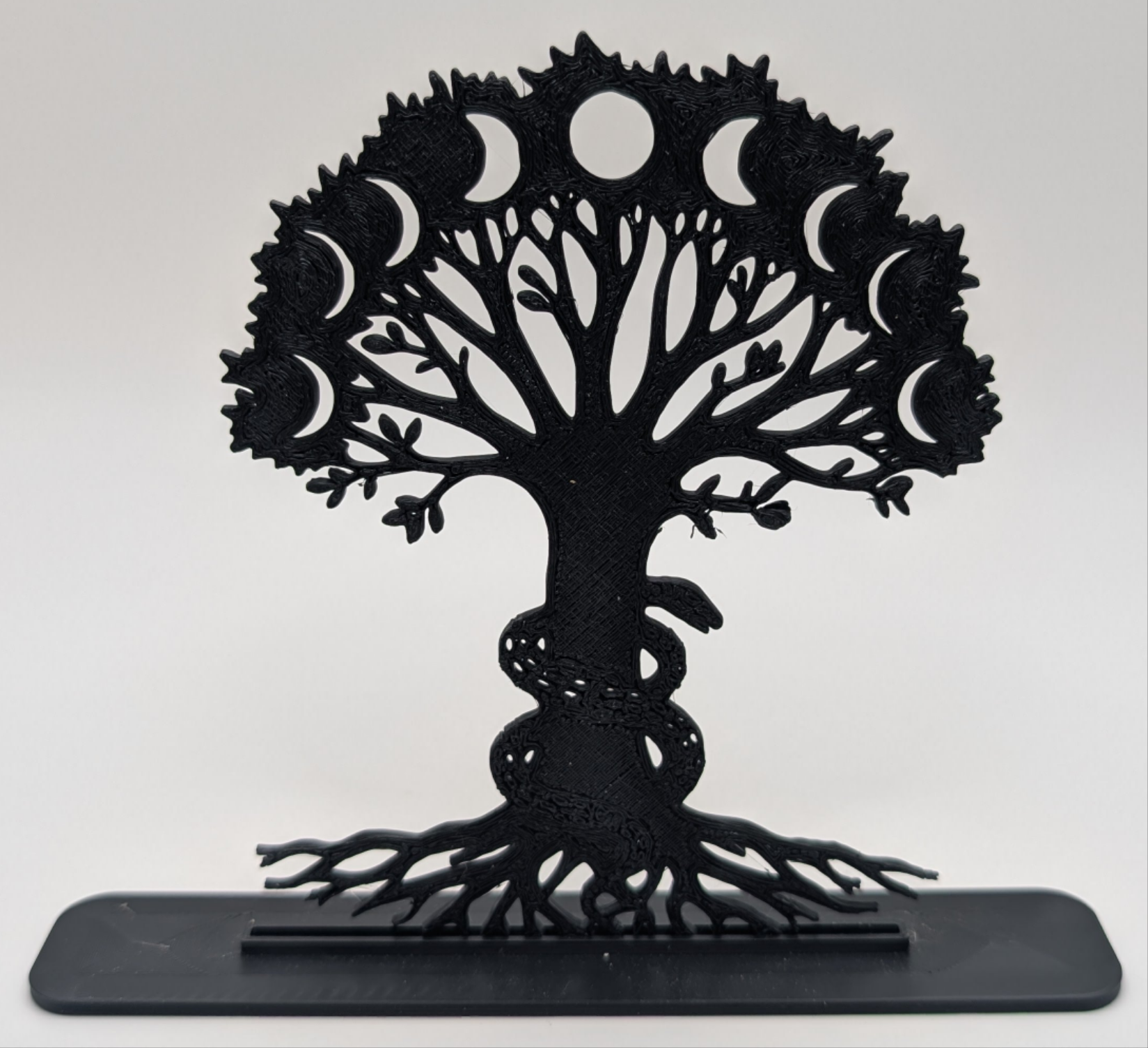 Modern Tree of Life tabletop ornament featuring lunar cycle and serpent detail, minimalist black design for home or altar use