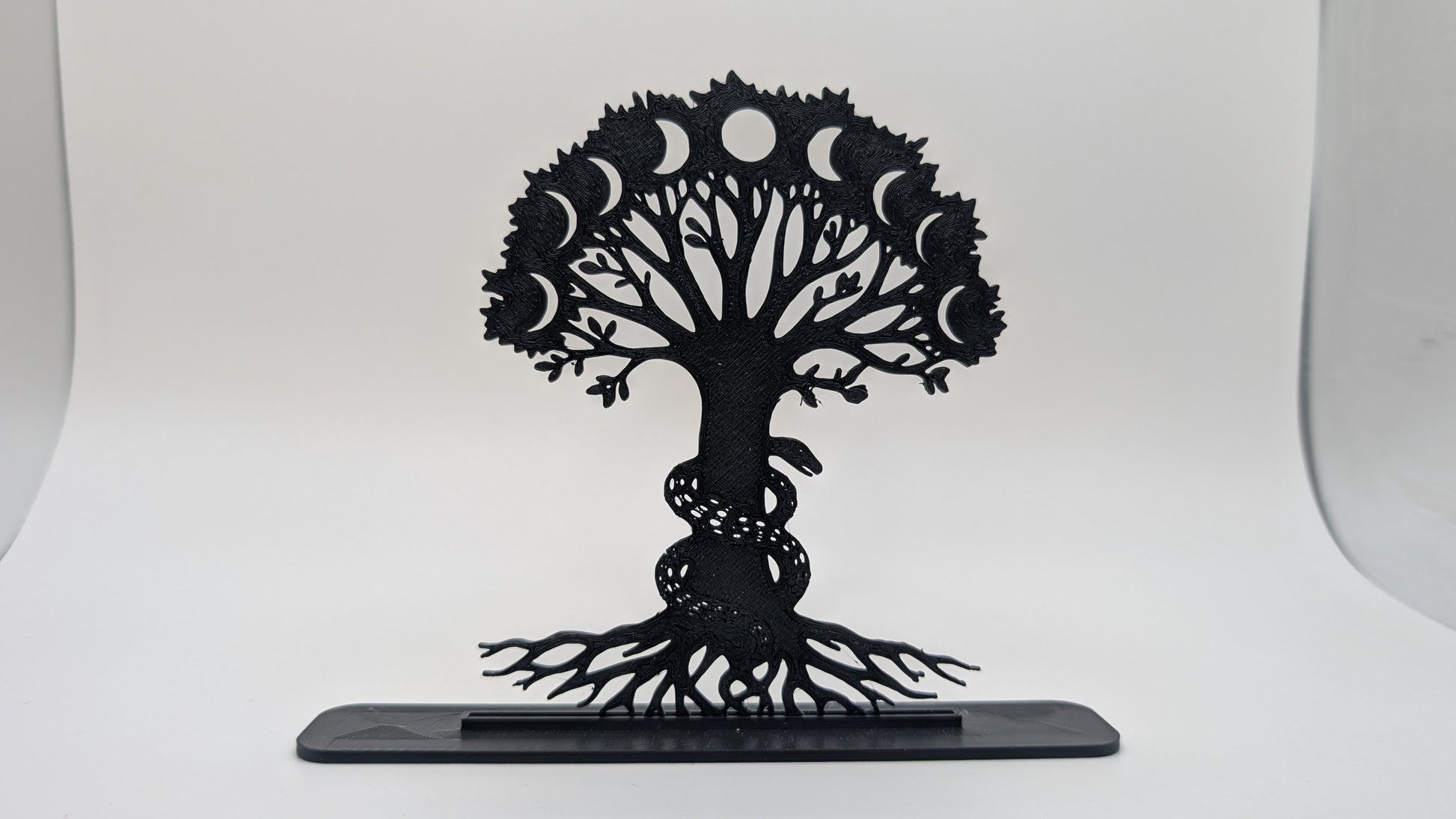 Black 3D-printed Tree of Life sculpture with moon phases and entwined serpent, symbolic spiritual decor on white background