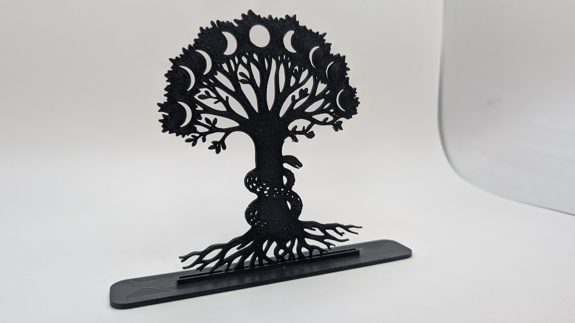 Gothic-style Tree of Life with crescent moons and serpent, 3D-printed black decorative statue isolated on white background
